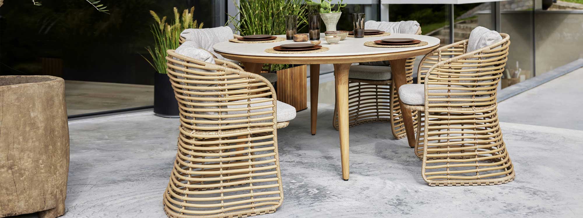 Image of Basket chair in natural cane with Aspect round teak table by Cane-line
