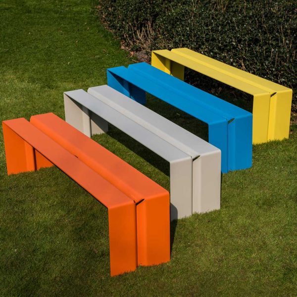 Image of row of 4 The Bended minimalist outdoor bench seats by Wünder, shown in orange, light-grey, blue and yellow