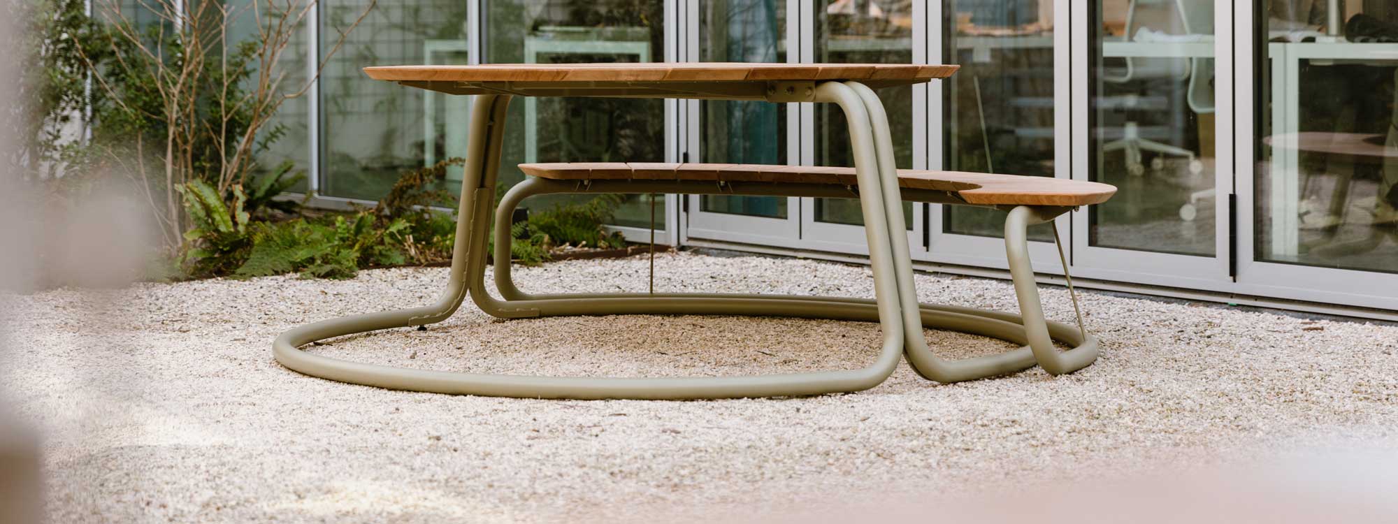 Image of Wünder's The Circle circular picnic table and benches in tubular stainless steel and sustainable afzelia wood