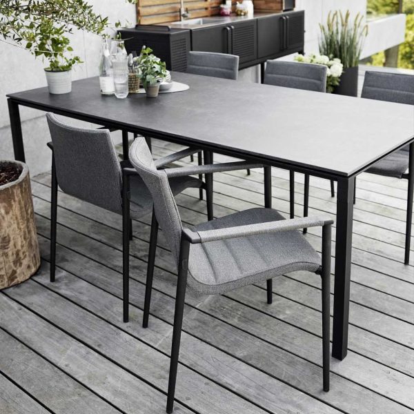 Image of Pure upholstered garden chair and Pure black dining table by Cane-line