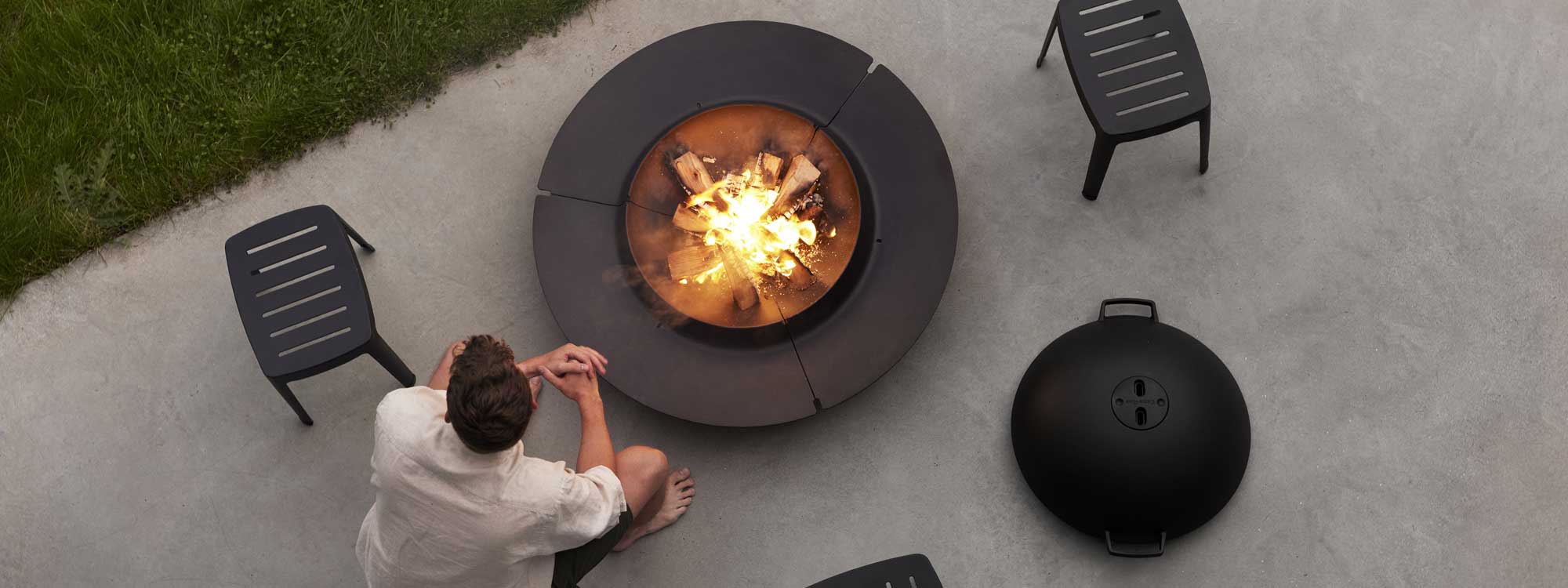 Image of an sat next to Cane-line Ember fire pit