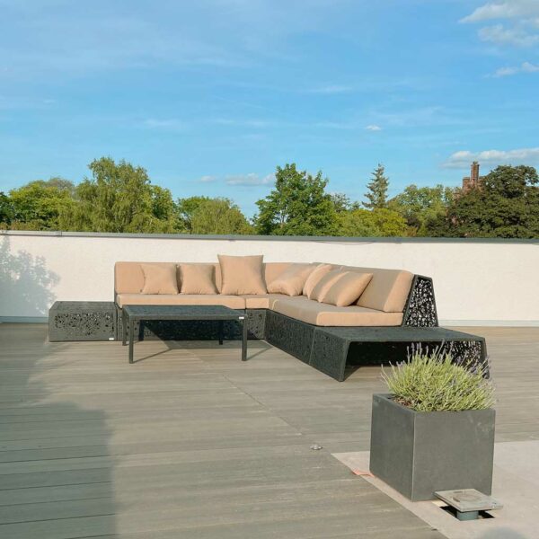 Image of Bios Lava Lounge black garden corner sofa by Unknown Furniture, with treetops and tops of Danish buildings in the background
