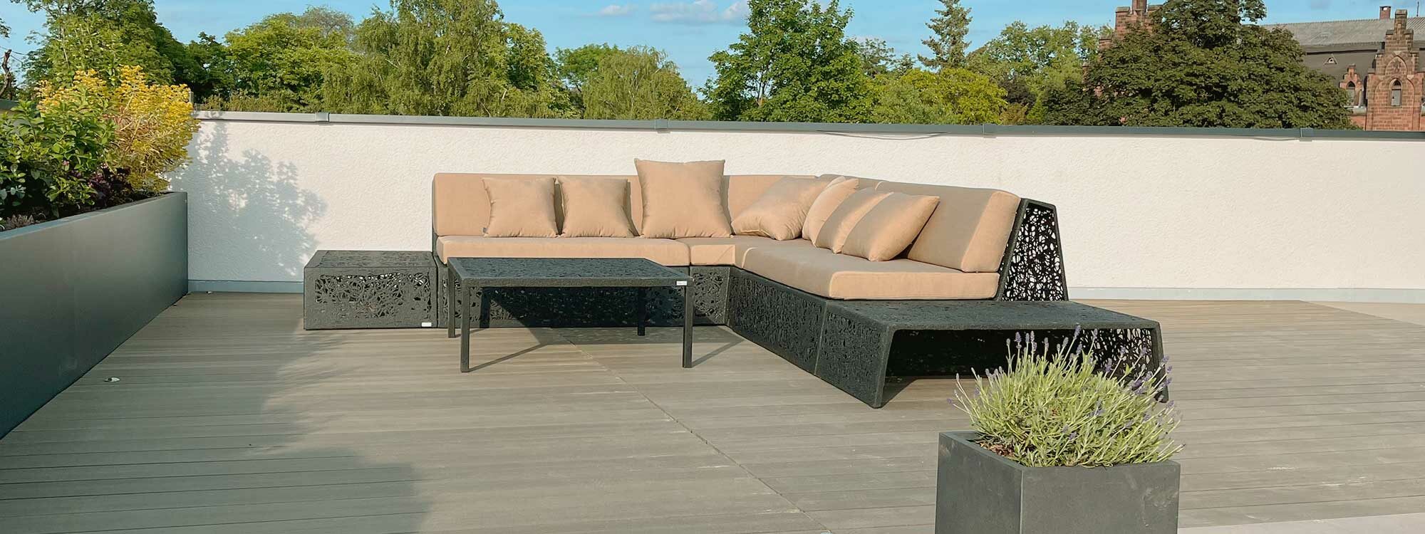 Image of Bios Lava Lounge outdoor corner sofa by Unknown Furniture, shown in rooftop with treetops and blue sky in the background