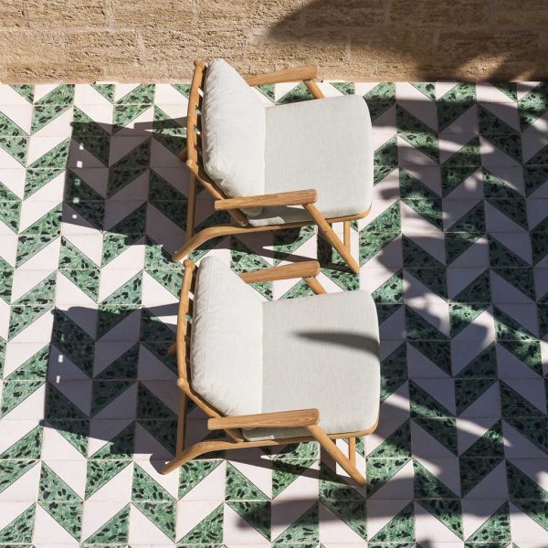 Image of aerial view of pair of RODA Levante teak lounge chairs on tessellating green and white tiled floor