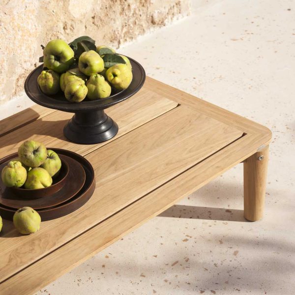 Image of RODA Levante modern teak low table carrying bowl of quinces