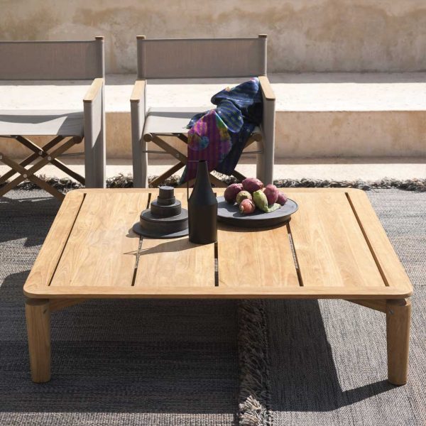 Image of RODA Levante teak low table with bowl of figs, with Orson outdoor director chairs in background