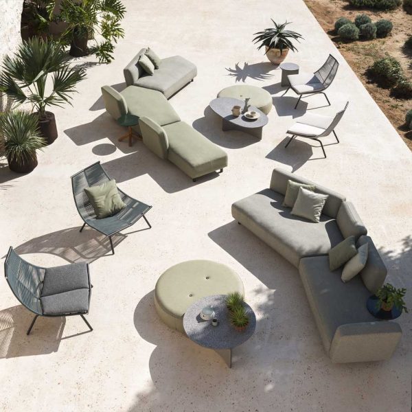 Image of aerial view of 2 RODA Mamba outdoor sofas with serpentine form, together with Laze outdoor relax chairs, Double circular poufs and Aspic terrazzo low tables