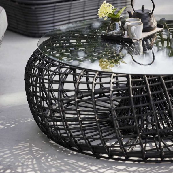 Image of Caneline Nest low table in black synthetic weave with clear toughened glass table top