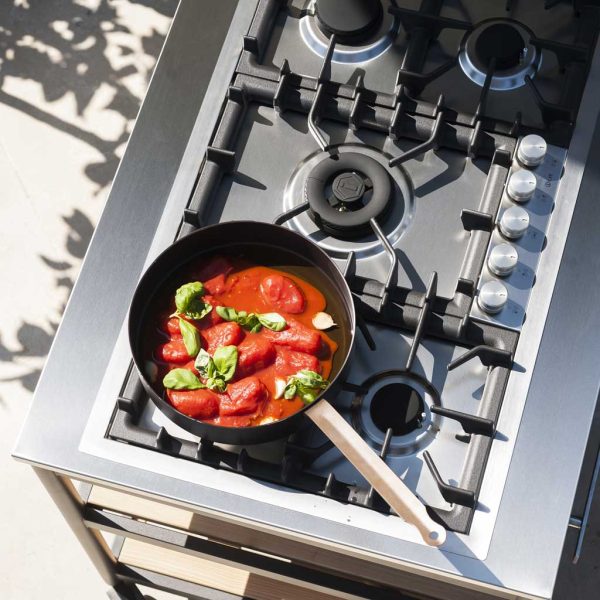 Image of aerial view of RODA Norma modern stainless steel gas BBQ, with pan of tomatoes and basil on hob