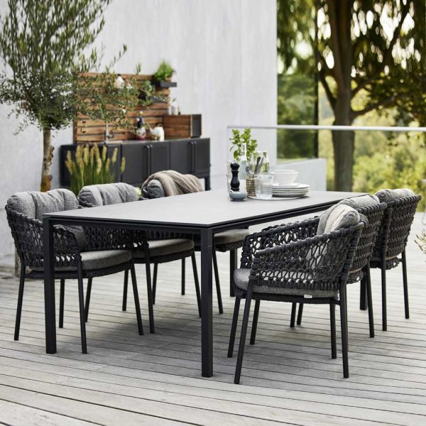 Image of dark grey Ocean soft rope chairs around lava grey rectangular Pure dining table by Caneline