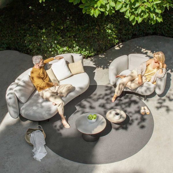 Couple relaxing on Organix Lounge garden sofa by Royal Botania