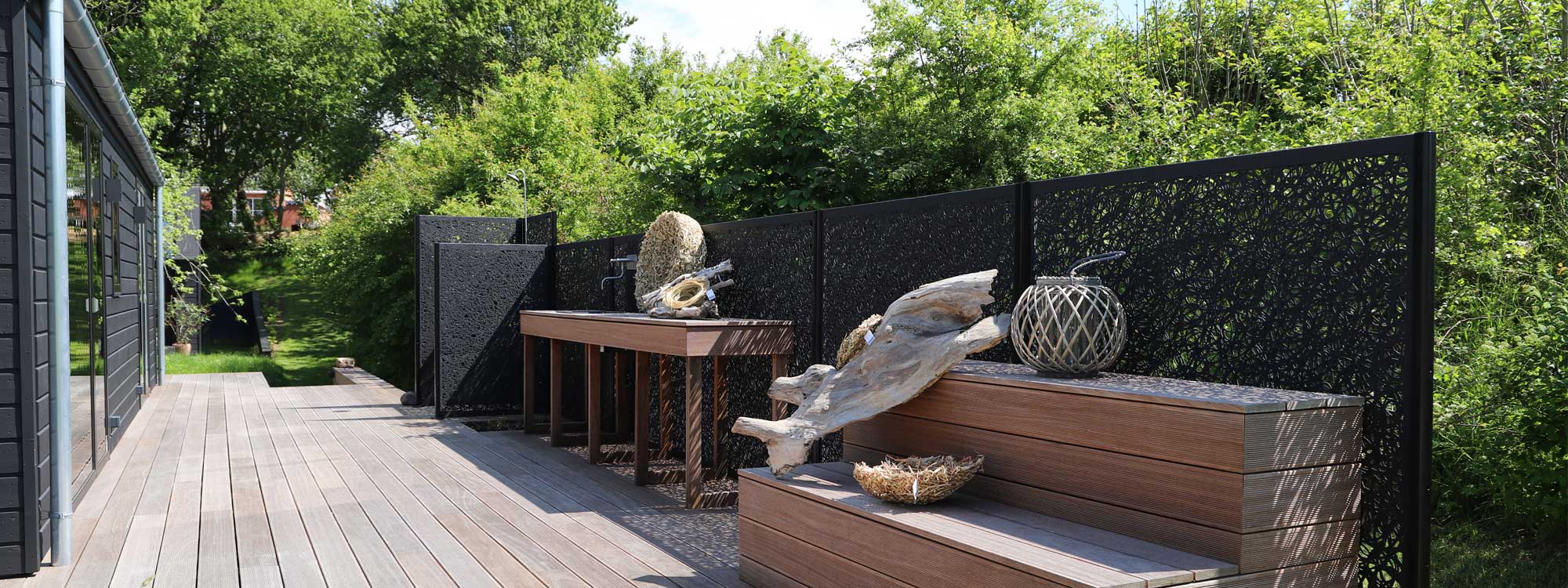 Image of black hand-made Lava panels by Unknown Furniture creating a fence against and outdoor kitchen