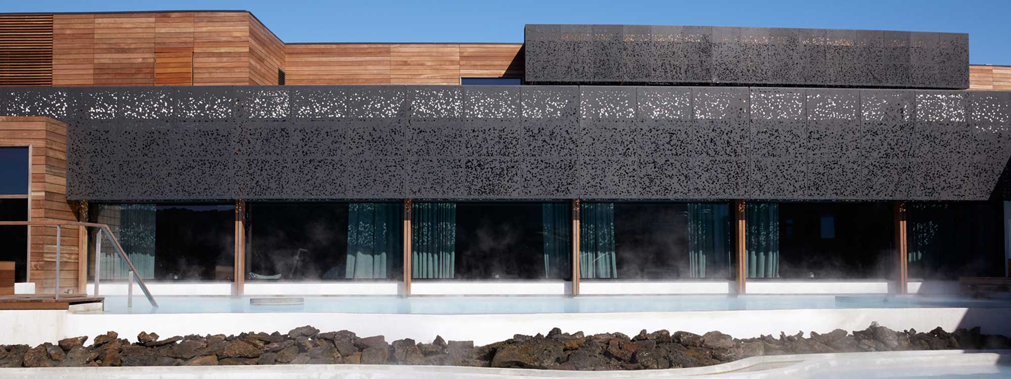 Image of modern cedar-clad building featuring row of black Lava panels in basalt fiber by Unknown
