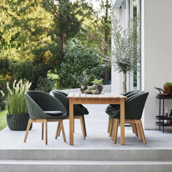 Peacock woven garden dining chair is a modern garden furniture chair in all-weather furniture materials by Cane-line luxury outdoor furniture