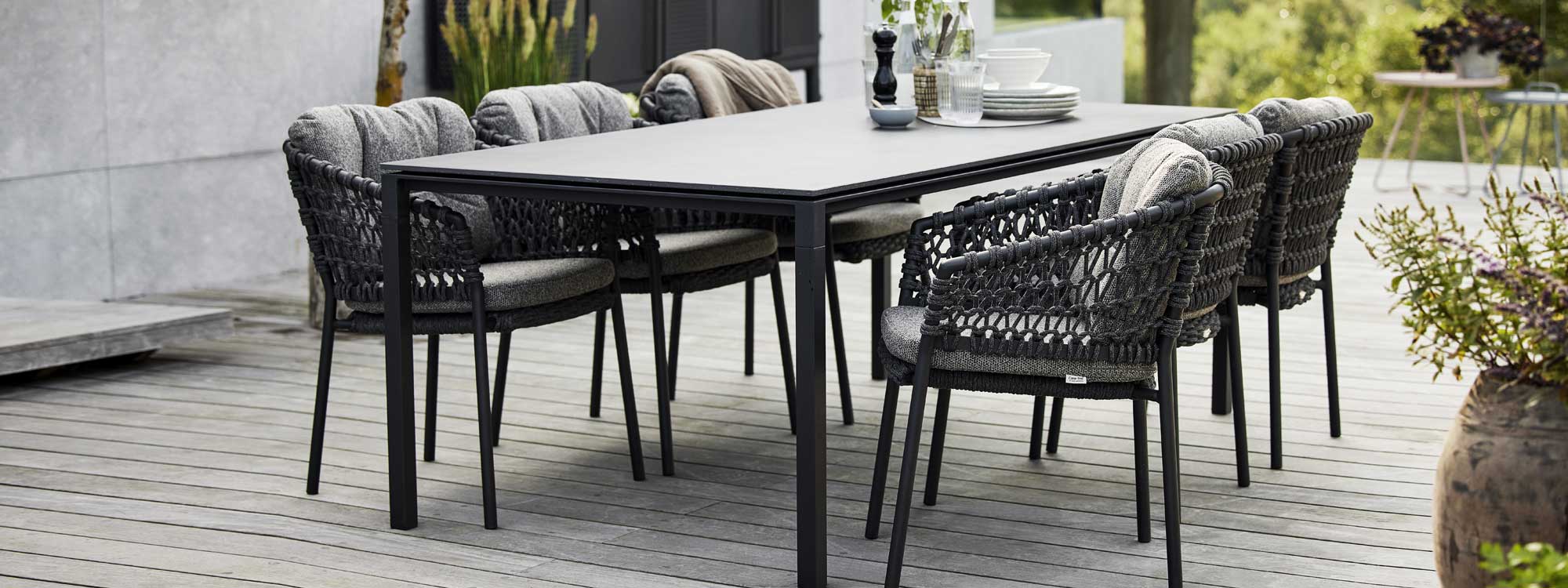Image of Pure minimalist garden table & Ocean dark grey garden chairs by Cane-line