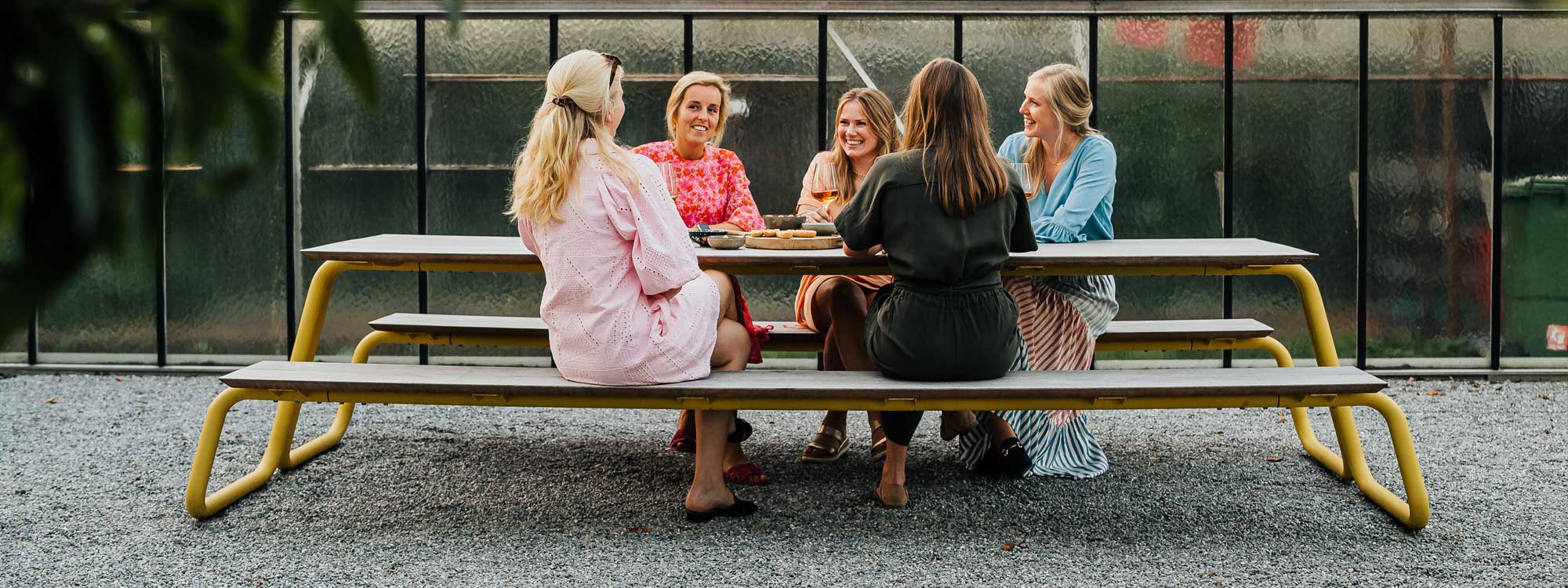 Image of 5 women sat enjoying each other's company on Wünder's The Table modern picnic table and benches
