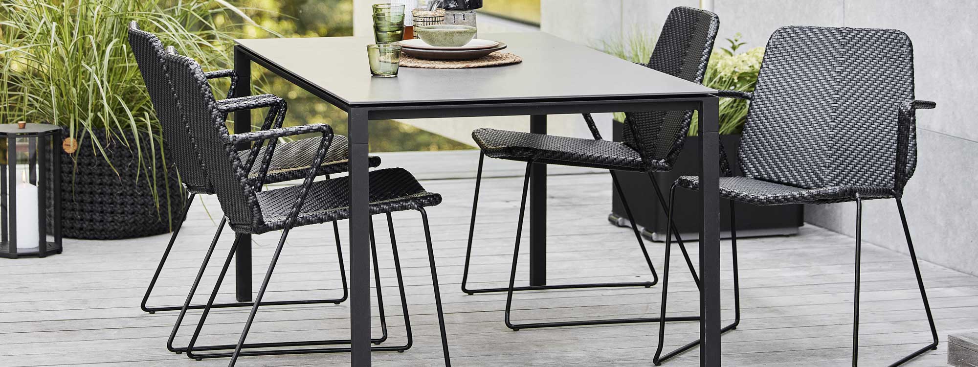 Image of Vision chairs without cushions and Pure dining table by Caneline garden furniture