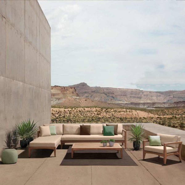 Image of Zenhit teak garden sofa against arid countryside background