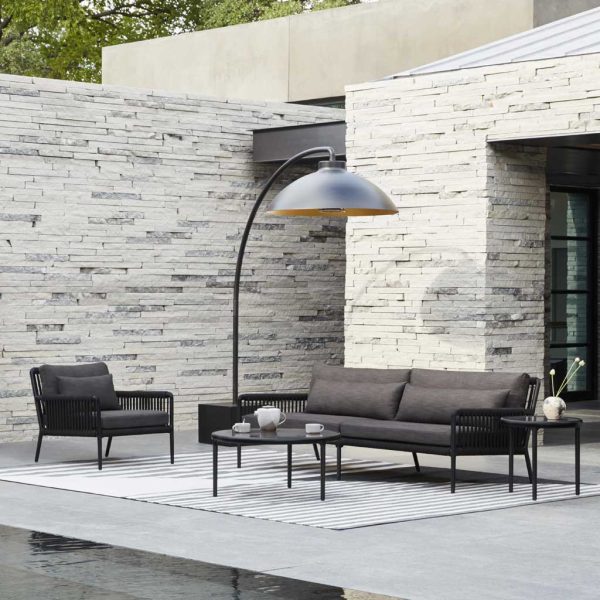 Image of black Heatsail Dome electric terrace heater above chic lounge furniture on hard landscaped terrace