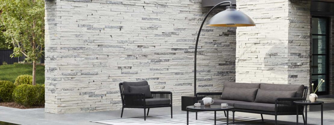 Image of black Heatsail Dome electric patio installed over black garden lounge furniture on chic landscaped terrace
