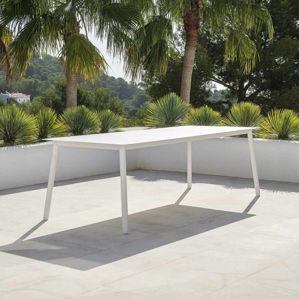 Image of Durham contemporary garden table with white tubular aluminium legs and rectangular ceramic table top by Jati & Kebon