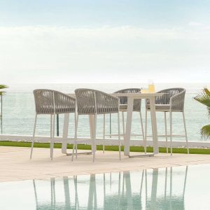 Image of Fortuna Rope white tub bar stools by Jati & Kebon on poolside, with sea in background