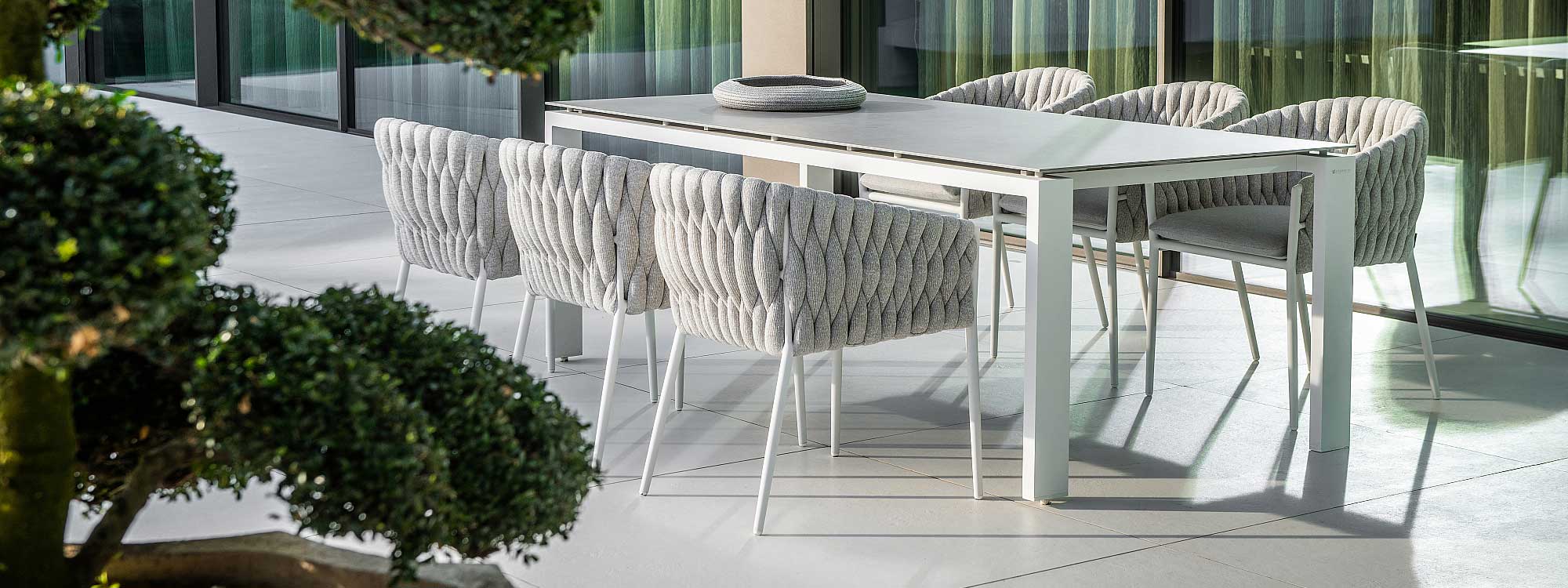 Image of white-grey Fortuna Socks garden tub chairs around a rectangular Jati & Kebon garden dining table