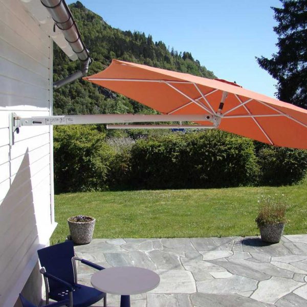 Image of tilted Prostor P4 wall mounted parasol with orange canopy