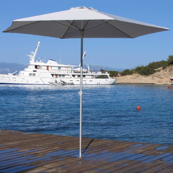 Image of Prostor P50 small mast parasol on wooden decking with superyacht and sea in the background