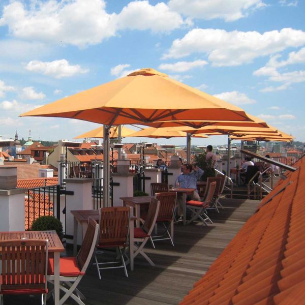 Image of Prostor P6 side post parasols with orange canopies on hotel rooftop terrace