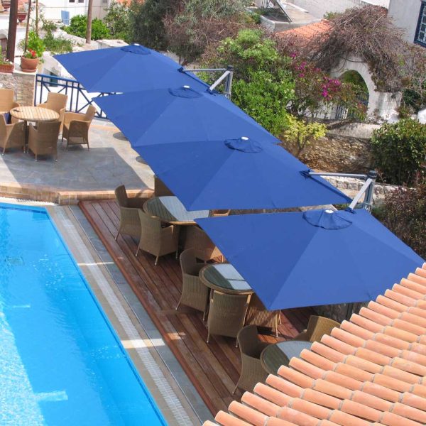 Image of row of Prostor P6 double canopy parasols along a sunny poolside