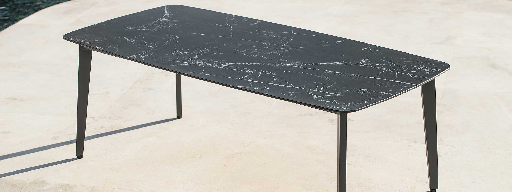 Image of Ritz black garden dining table with dark marble ceramic table top by Jati & Kebon
