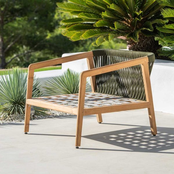 Image of Ritz teak garden easy chair with Polyolefin rope seat and back casting shadows on the terrace floor beneath
