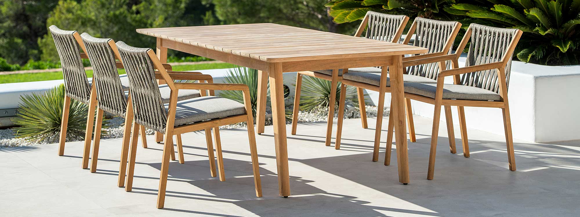 Image of Ritz teak garden table and chairs with Taupe Polyolefin rope seat and back on sunny terrace