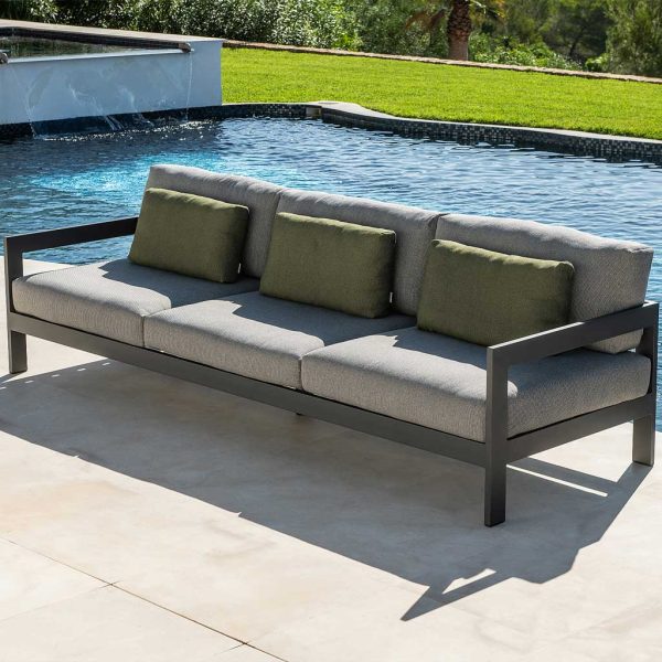 Image of Vigo XL 3 seater garden sofa in charcoal coloured aluminium, with grey and green cushions, shown on sunny poolside
