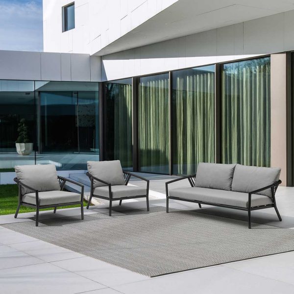 Image of Kapra black outdoor lounge furniture with grey cushions on minimalist terrace