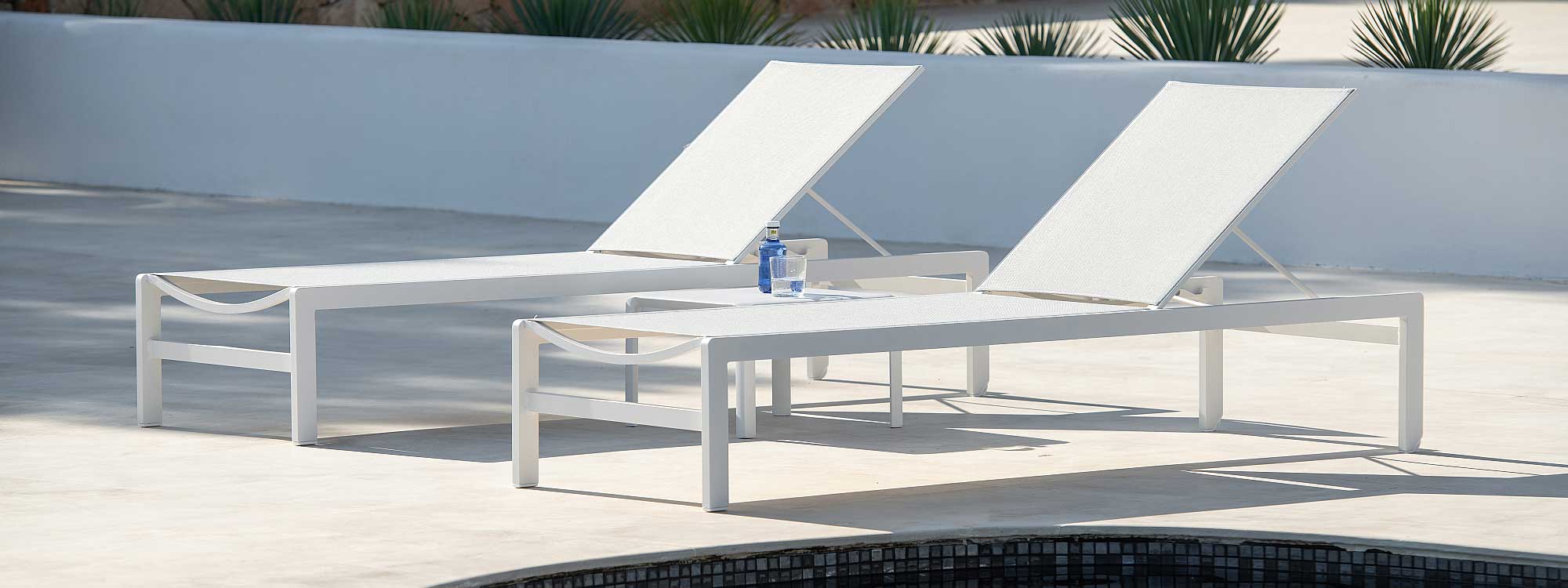 Image of pair of Sylt white aluminium sun loungers by Jati & Kebon on sunny poolside