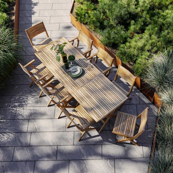 Image of birds eye view of Cane-line Flip folding teak dining set surrounded by grasses and lush planting