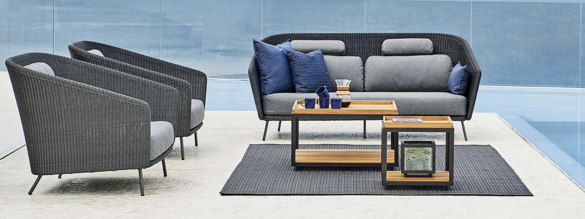 Image of Cane-line Level low tables on outdoor rug, surrounded by Cane-line Mega garden lounge set