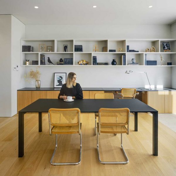 Image of woman sat at 45 modern rectangular garden table in anthracite colour finish, shown inside a house