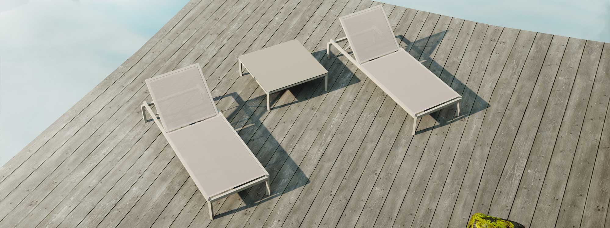 Image of aerial view of pair of Oiside 45 minimalist sun loungers and a low table in between, shown on wooden decking in the sun