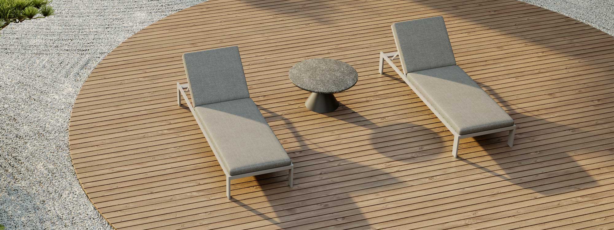 Image of pair of Beam Aluminium sun loungers on circular wooden deck with Drums modern low table in the centre, surrounded by carefully raked gravel in Japanese style