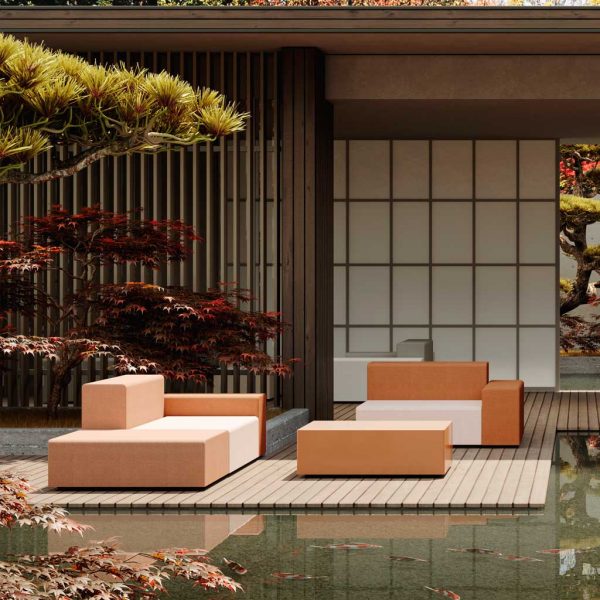 Image of Oiside modular garden sofa in contrasting coloured upholstery on decking in tranquil water garden, with Japanese minka-style building and screens in the background