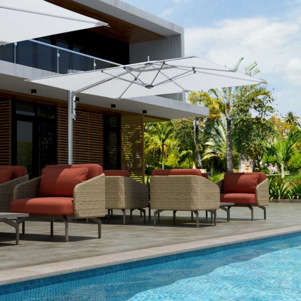 Image of white Tuuci cantilever parasol on poolside with lounge furniture beneath the canopy