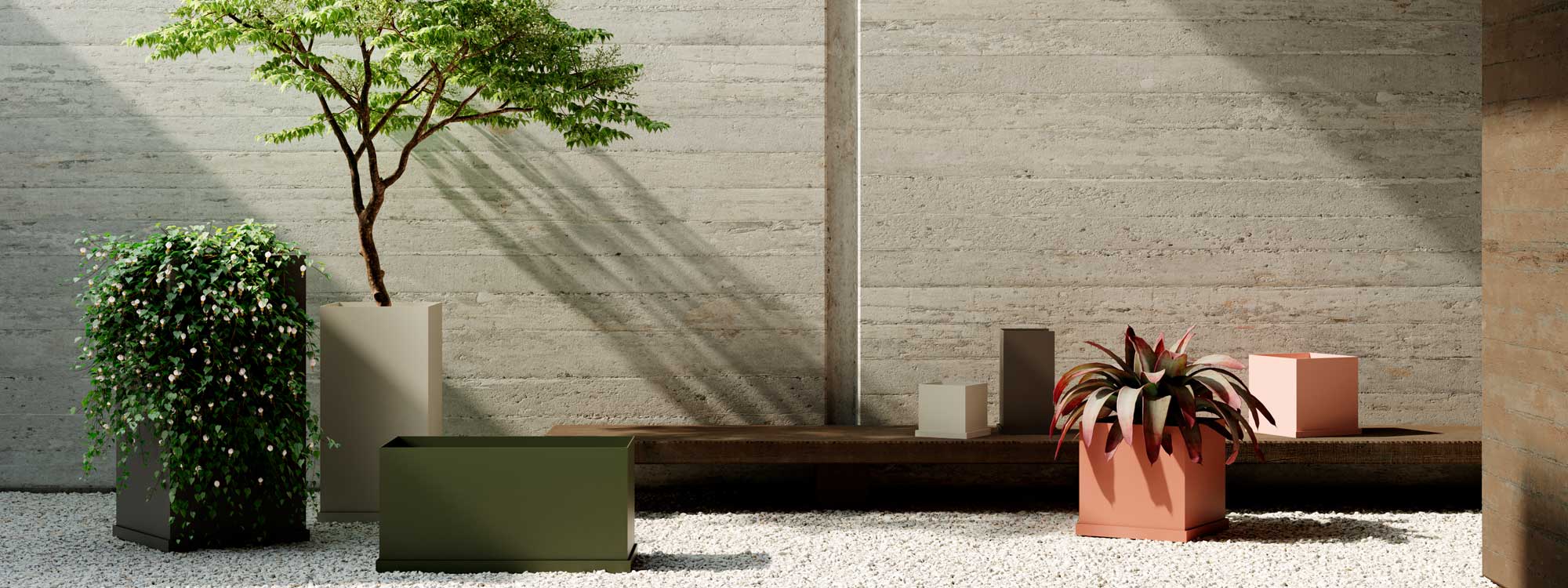 Image of configuration of various sizes and colors of OiPots modern geometric planters, shown on pale gravel floor with poured concrete wall in the background