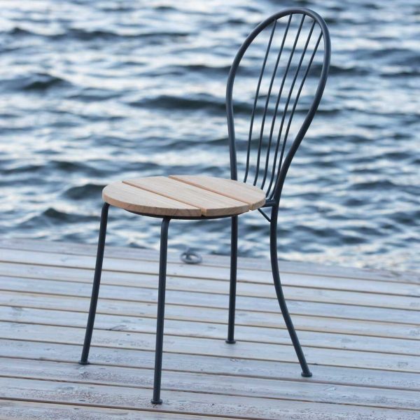 Image of Akleja contemporary outdoor bistro chair by Grythyttan Stålmöbler, shown on wooden deck with rippled water in the background