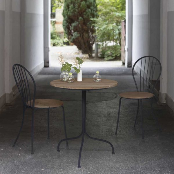 Image of pair of Grythyttan Akleja small bistro chairs and bistro table in outdoor passageway