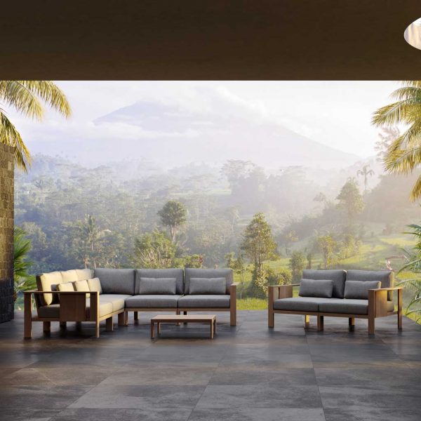 Image of Beam luxury outdoor corner sofa in FSC hardwood by Oiside, with hill shrouded in mist in the background