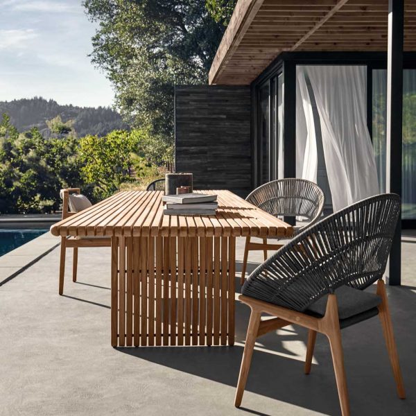 Image of Gloster Bora teak retro garden chair and Deck large teak dining table on sunny terrace