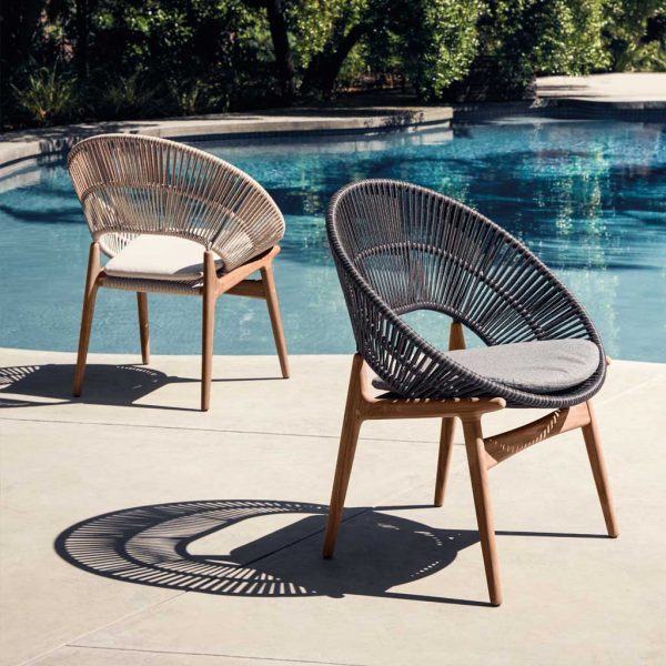 Image of different finishes of Bora teak and wicker garden chairs by Gloster on sunny poolside